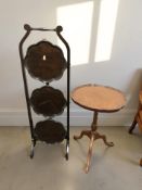 A reproduction walnut tripod occasional table, height 53 cm, and a folding mahogany cake stand.