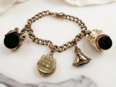 A 9ct yellow gold graduated bracelet with four suspended fobs of bloodstone, amethyst and citrine,