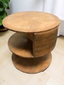 An Art Deco walnut circular book table, with plate glass top,