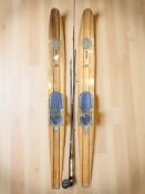 A pair of vintage wooden skis, fishing rods, etc.