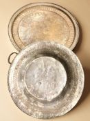 Two eastern embossed metal chargers, largest 68 cm diameter.