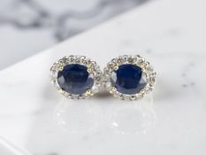 A pair of 18ct gold sapphire and diamond cluster earrings