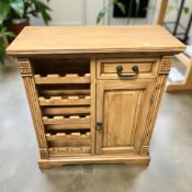 A modern pine side cabinet with bottle rack, 87 cm x 39 cm x 100 cm.