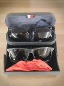 A pair of Tommy Hilfiger sunglasses and a pair of Hugo Boss sunglasses, both in cases.