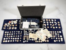 An aluminium case containing world coins and bank notes, Australia, South Africa,