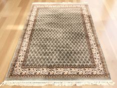 A machine-made rug of Iranian Erivan design, 257 cm x 173 cm.