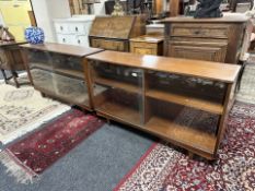 Pair of 20th century teak sliding glass door low bookcases,