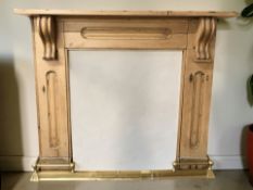 An antique pine fire surround and a brass telescopic fire curb.