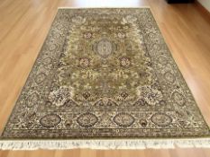 A machine-made Iranian-design carpet on green ground,