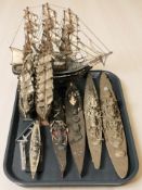 A group of scale model wooden and die cast ships and battleships.