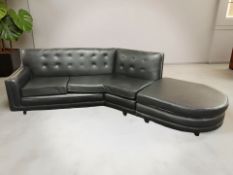 A black buttoned vinyl L-shaped corner settee and matching footstool,