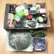 A collection of fishing equipment including various spools of line, netting, lead weights,