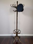 A stained bentwood hat and coat stand, height 193 cm, together with a cap.