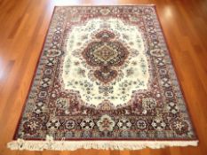 A machine made rug of Iranian design, 210 cm x 146 cm.