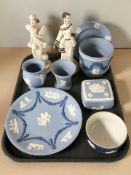 Several items of blue and white Wedgwood Jasperware and two Capodimonte bisque figures of ladies.