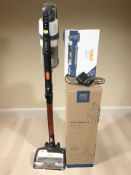 A Vax stick vacuum, in box, a further Vax cordless pro kit and a Shark stick vacuum.