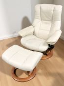 A Norwegian Ekornes Stressless cream leather swivel lounge armchair and matching footstool.