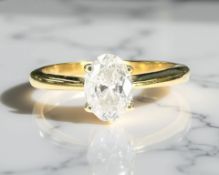 An 18ct yellow gold diamond solitaire ring, the oval shaped diamond approximately 0.