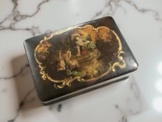 A continental lacquered box with a panel depicting a figure by a well with two children,