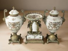 A continental gilt metal mounted three piece ceramic garniture set,
