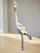 A large enamelled metal statue of an exotic bird,
