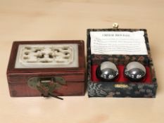 Two pairs of Chinese medicine balls in boxes