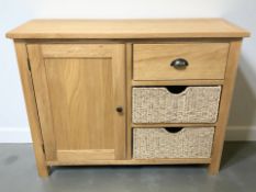 A modern oak side cabinet, fitted cupboard, drawer and two further wicker drawers,