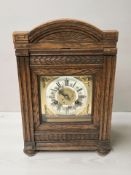 An Edwardian carved oak eight day mantel clock,