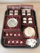 A group of boxed modern silver plated napkin rings, name card holders, drinks coasters.