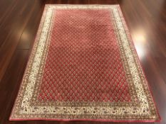 A machine made rug of Iranian design, 250 cm x 165 cm.