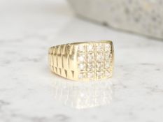 A 9ct gold gent's signet ring, pavé set with diamonds, the stated total diamond weight 0.