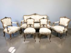 A French carved walnut seven-piece lounge suite, circa 1920, comprising of a three-seater settee,