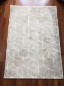A modern machined rug on grey ground, 170 cm x 120 cm,