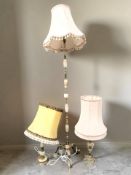 A gilt metal and onyx standard lamp, and two similar table lamps.