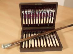 A walnut canteen of EPNS fish cutlery with silver ferrules and faux ivory grips,