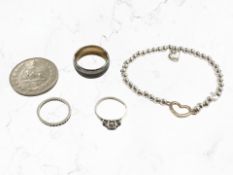 A costume bracelet, tungsten band ring, silver dress ring, eternity ring and a continental coin.