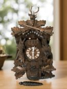 A reproduction carved beech black forest style cuckoo clock.