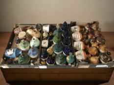A collection of empty earthenware whisky jugs bearing various advertising.