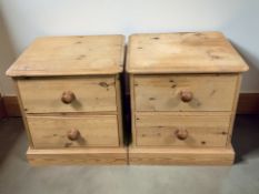 A pair of 20th century pine two drawer bedside stands, width 52 cm.
