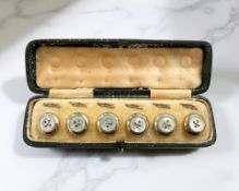 A set of six antique yellow metal dress studs in case.