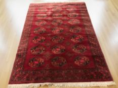 A machine made rug of Afghan design, 253 cm x 170 cm.