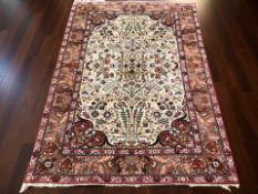 A woolen rug of Iranian Kirman design, 220 cm x 151 cm.