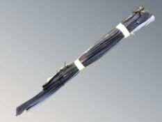 A bundle of fishing rods in cloth covers including a Ron Thompson, Hardcore Pro 8ft carbon rod, etc.