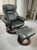 A contemporary swivel lounge armchair upholstered in stitched black faux leather,