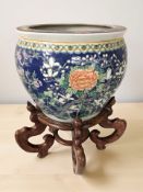 A 20th century Oriental earthen ware planter on hardwood stand,