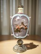 A gilt metal mounted twin-handled glass bottle vase and stopper depicting a nude female astride a