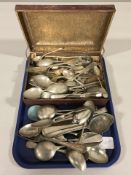 An antique tin containing assorted EPNS flatware.