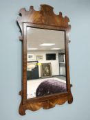 A reproduction chippendale style mirror, 71 cm x 40 cm.