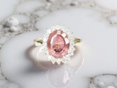 An 18ct yellow gold pale pink sapphire and diamond cluster ring,