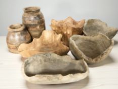 A collection of naturalistic turned and carved wooden bowls and other vessels.